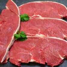 Grass Fed Beef Rump Steaks - 1kg, premium quality cuts of beef shown with fresh herbs on a black background.
