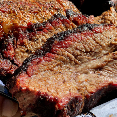 Delicious smoked brisket showcasing a perfectly cooked, juicy texture and rich flavor.