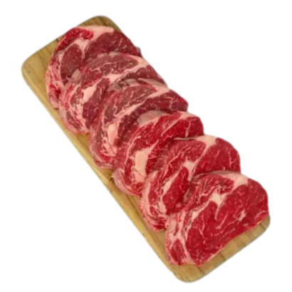Grass Fed Scotch Fillet Steaks displayed on a wooden platter, showcasing rich marbling and tenderness.