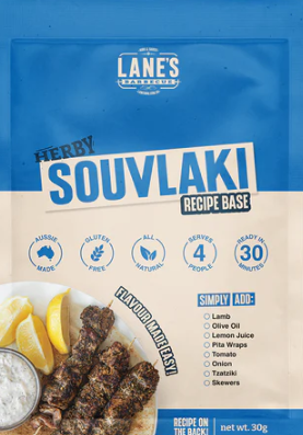 Lane's Herby Souvlaki Recipe Base packaging featuring grilled souvlaki skewers, lemon, and serving suggestions.